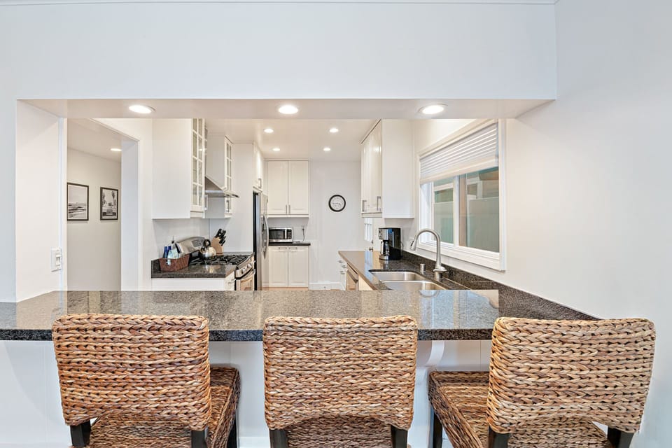 Additional barstool seating for three offers a casual gathering spot for morning coffee, cocktails, or conversation
                