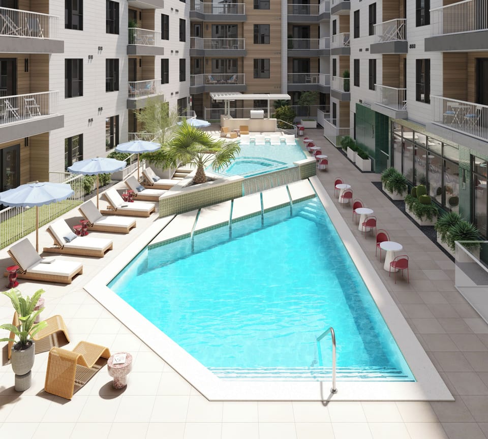 Elevated view of the resort offers a communal pool, outdoor kitchen, and multiple lounge areas.