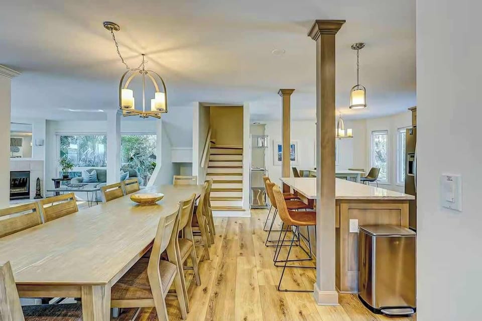 Your spacious open-concept kitchen and dining area flows seamlessly together, perfect for cooking meals and gathering around the large dining table.