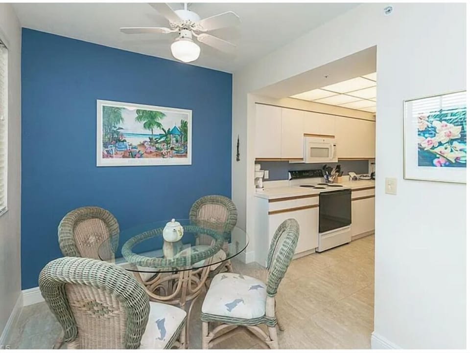 Settle in at your cozy dining nook with wicker chairs and a glass table, perfect for morning coffee or casual meals. The open layout flows right into your kitchen, making everything effortlessly convenient.