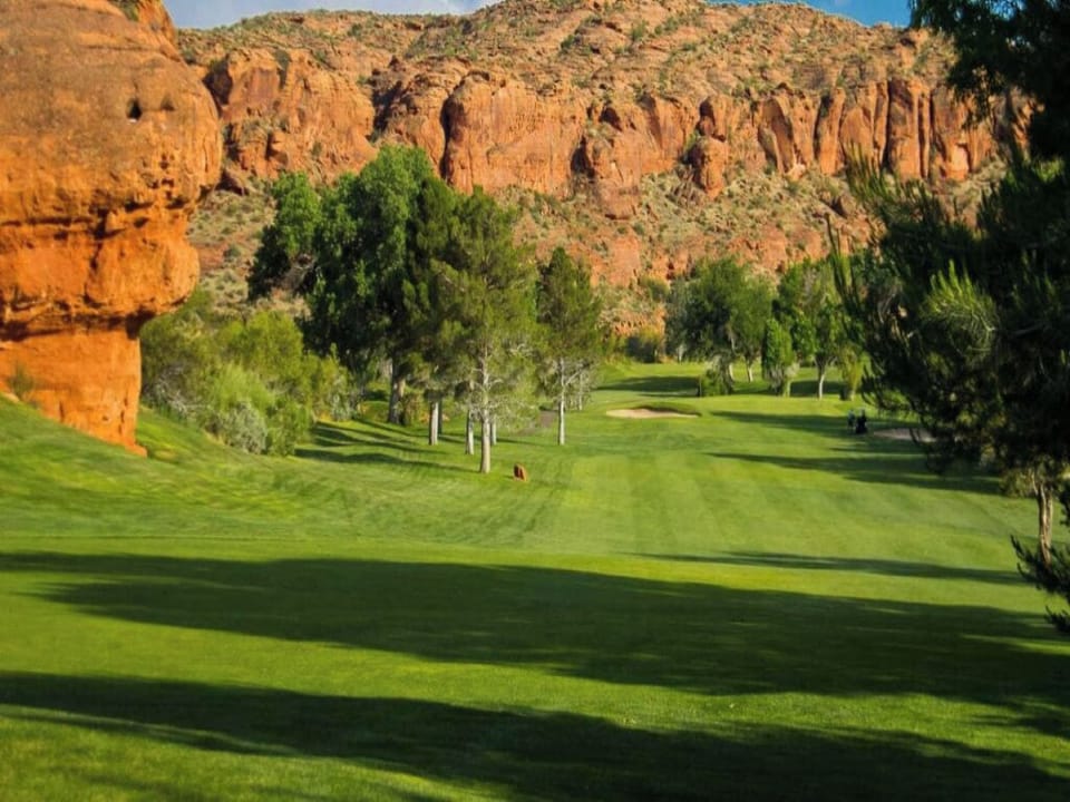 Unwind with sunrise fairway views framed by towering red cliffs.
