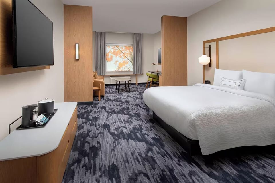 Relax in a spacious modern room with a cozy sitting area.