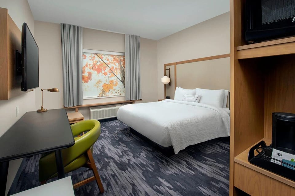 Unwind in crisp linens beside a bright, calming view.