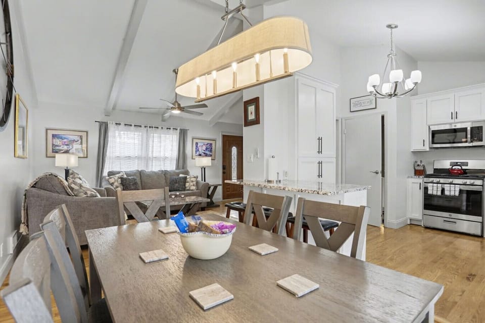 Spacious dining area adjacent to kitchen and living room with vaulted ceilings enhancing the open feel.