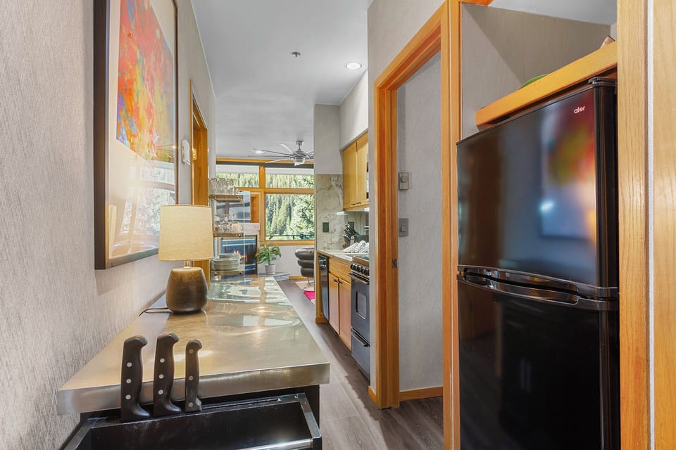 Step into your sleek, fully-equipped kitchen where natural light streams through the windows and every modern appliance is at your fingertips, ready for crafting delicious meals during your stay.