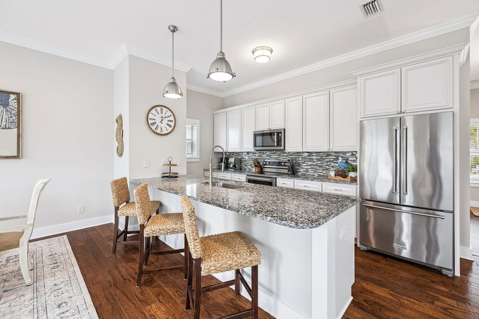 Kitchen features granite countertops, stainless appliances, and a breakfast bar