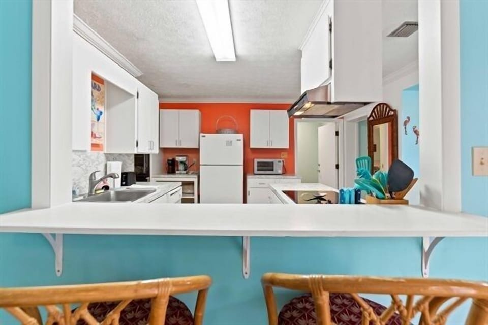 Bar seating ideal for quick breakfasts, coffee chats, or keeping the cook company.