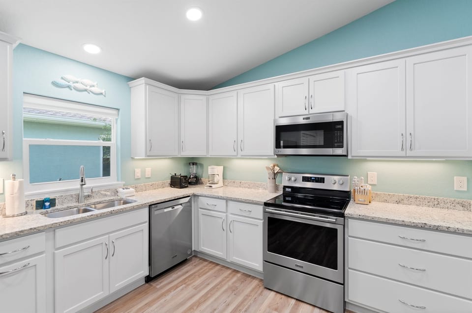 A bright, fully equipped kitchen designed for ease and connection, with generous counter space, modern appliances, and everything you need to cook comfortably during your stay.