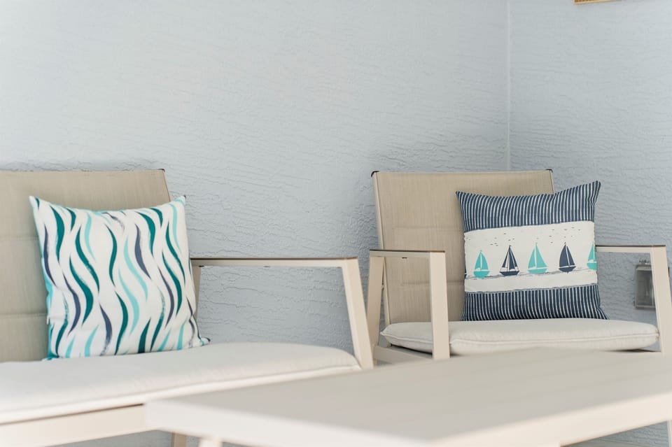 Comfortable outdoor seating with soft coastal touches, ideal for enjoying fresh air, morning sunshine, or peaceful evenings outside.