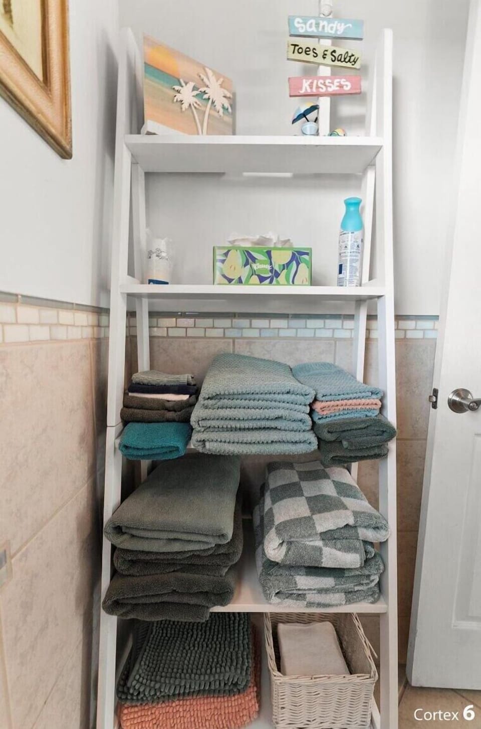 Freshly stocked linens and towels, neatly stored and ready for guest use.
