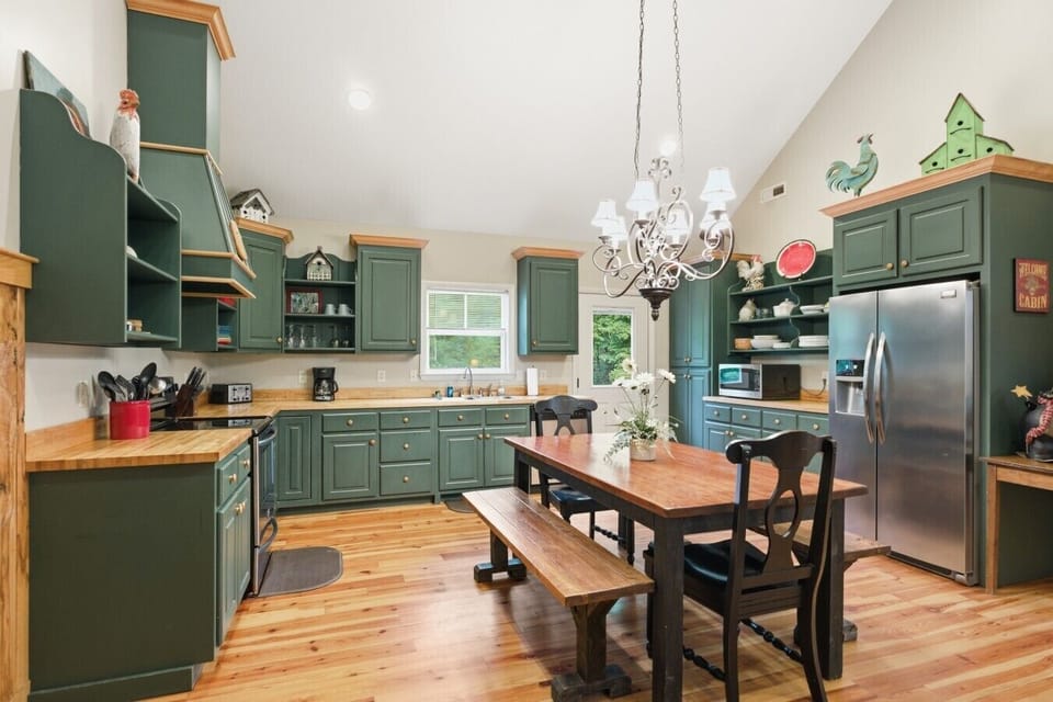 Kitchen | Green Cabinetry & Butcher Block Counters | Dining Table & Chandelier