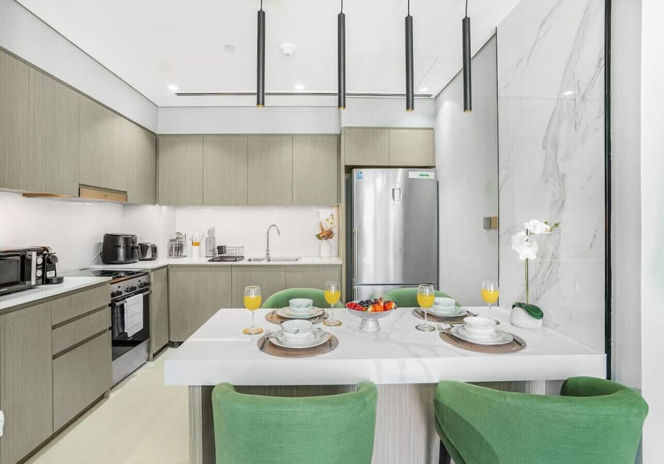 Modern Kitchen & Dining: A fully equipped modern kitchen with built-in appliances, spacious countertops, and a stylish dining island with comfortable seating—perfect for cooking and enjoying meals.