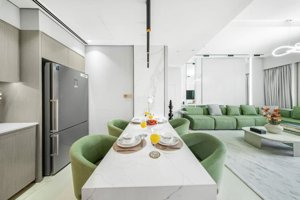 Open-Plan Dining & Living: A stylish open-plan space featuring a dining table with comfortable seating, modern kitchen access, and a spacious living area—ideal for dining, relaxing, and entertaining.