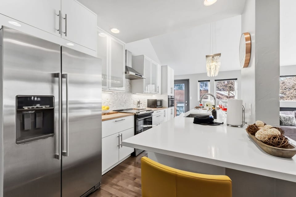 Updated kitchen with stainless steel appliances and everything needed to cook a meal at the home after a day in the mountains.