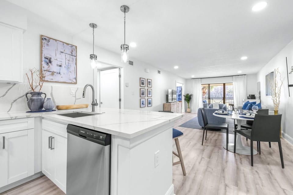 Updated kitchen with large island, quartz countertops, and stainless steel appliances.