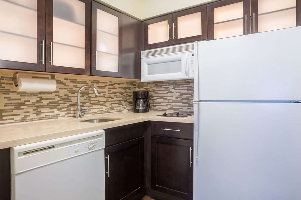 Brew morning coffee and prep snacks in the efficient kitchen.
