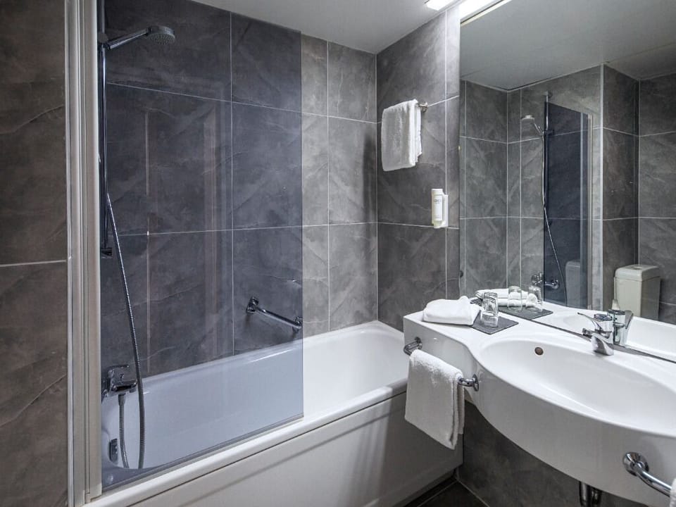 Refresh in a modern bath with tub and fresh towels.