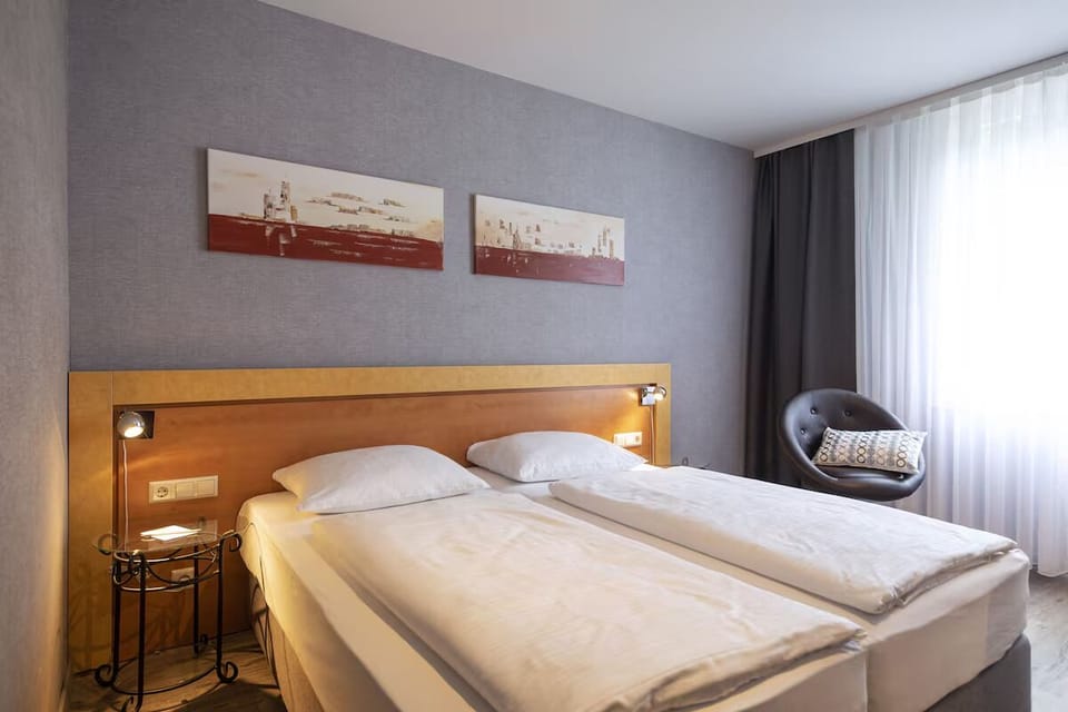 Sink into crisp bedding with convenient reading lights bedside.