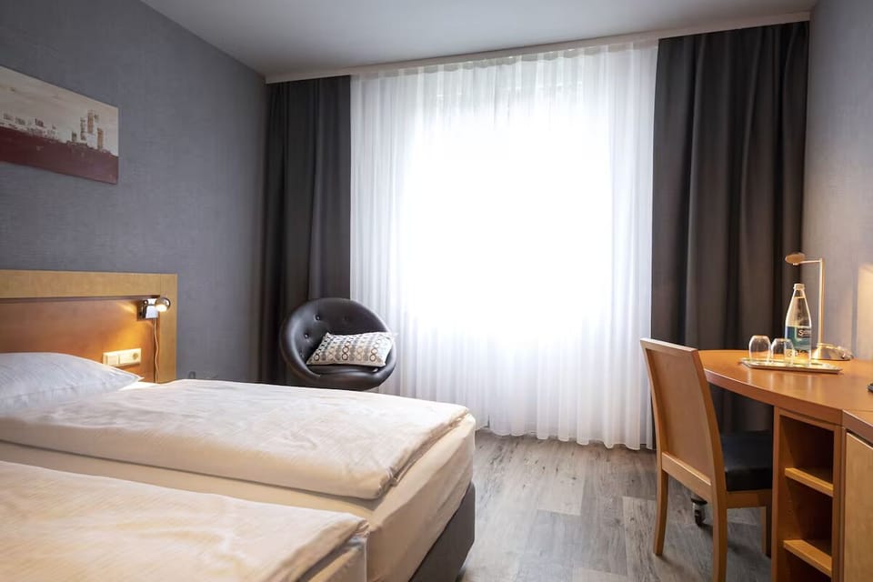 Wake up refreshed beside soft linens and sunlit window.