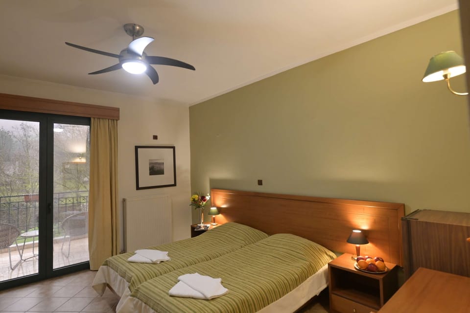 Warm and Comfortable Bedroom with Wooden Floors and Balcony Access