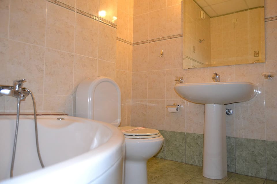Clean and Spacious Bathroom with Bathtub and Vanity