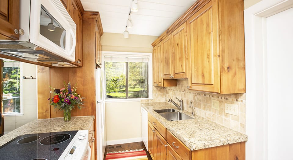 Cook with ease on granite counters in a bright kitchen.