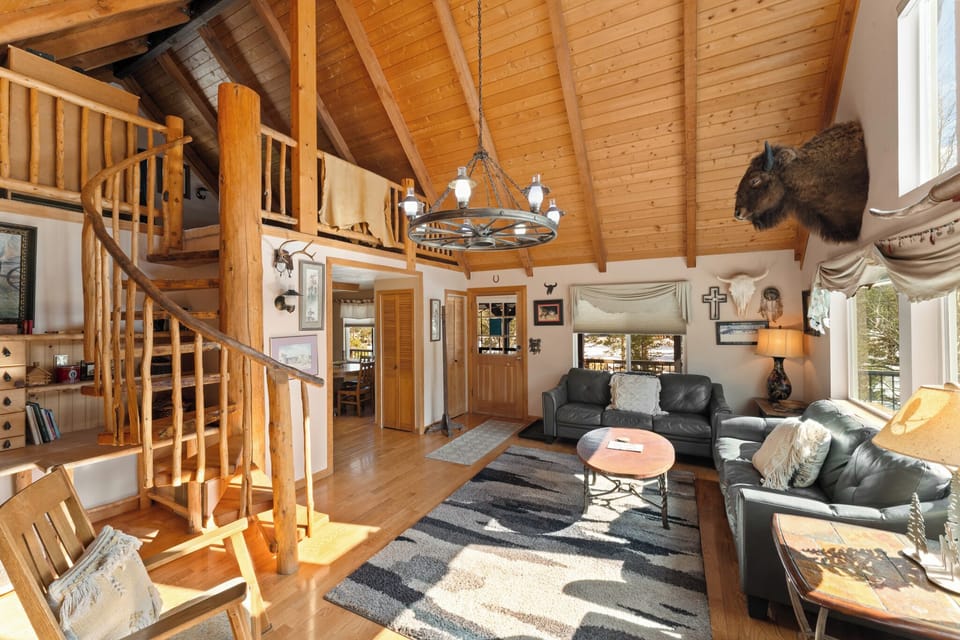 Step into your cozy cabin retreat with soaring wood-beamed ceilings and rustic charm that makes you feel right at home.