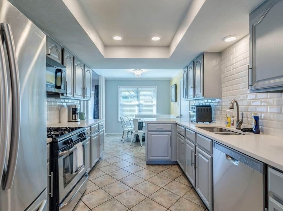 Kitchen has Dishwasher, Microwave, Refrigerator, Electric Stove, Oven, Dishware, Filter Coffee Maker. 