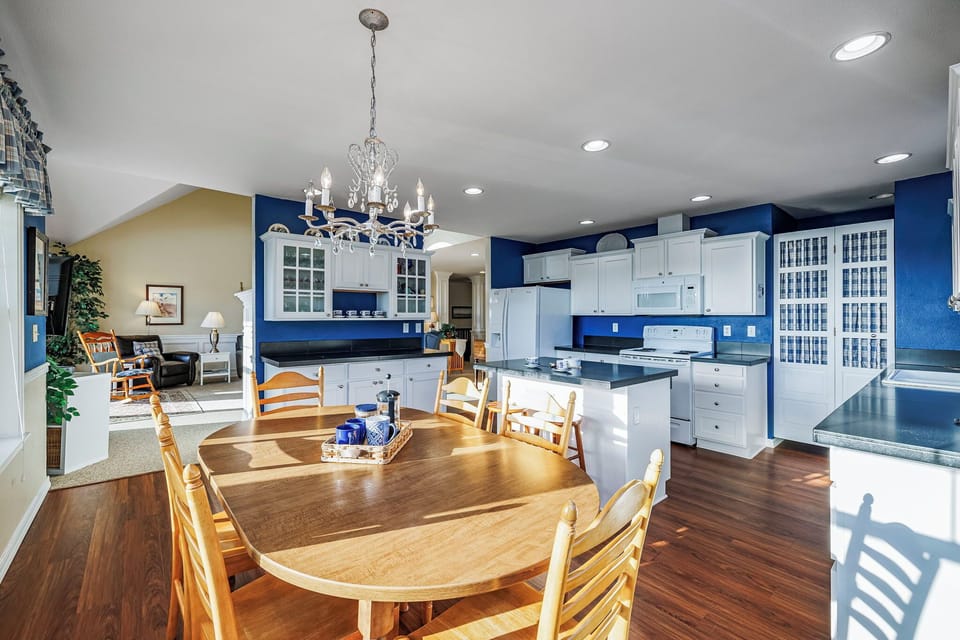 Open coastal kitchen with plenty of counter space and a dining table with seating for six, ideal for shared meals and conversation