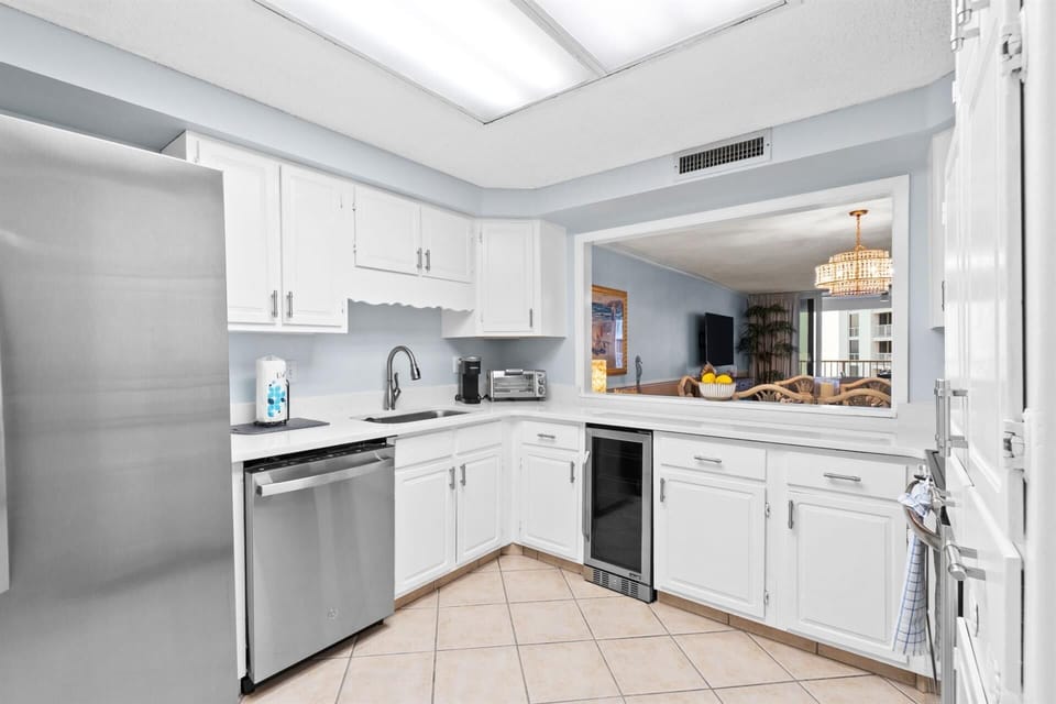 Your fully-equipped kitchen features stainless steel appliances and gleaming white cabinets, perfect for preparing meals during your stay.