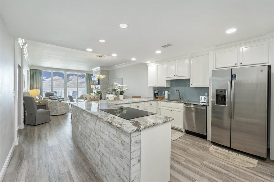 Your spacious kitchen flows into the living area, perfect for cooking while chatting with loved ones on your oceanfront getaway.