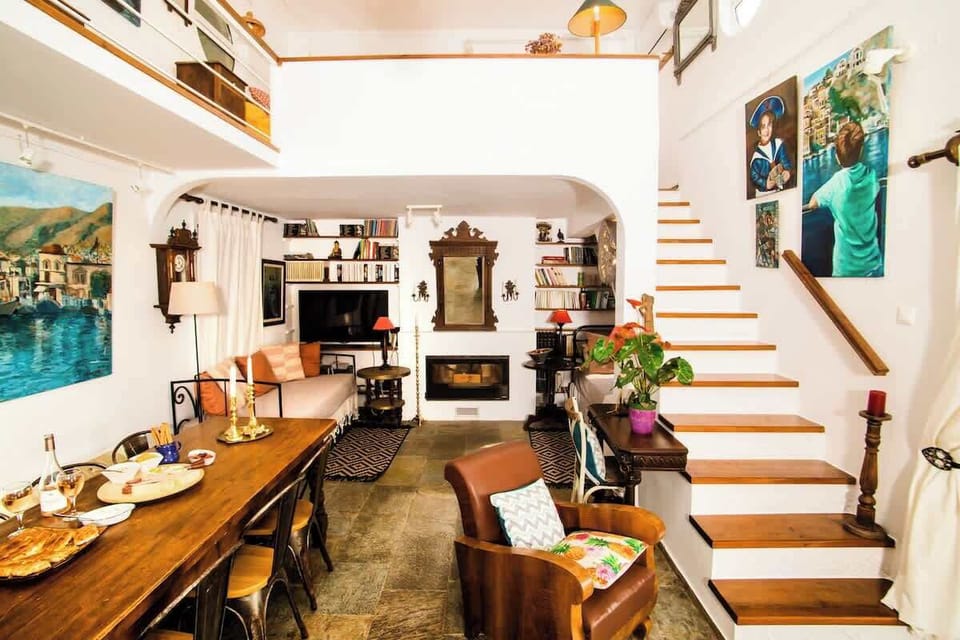 Inviting Split-Level Living Room with Art-Filled Walls and Fireplace
