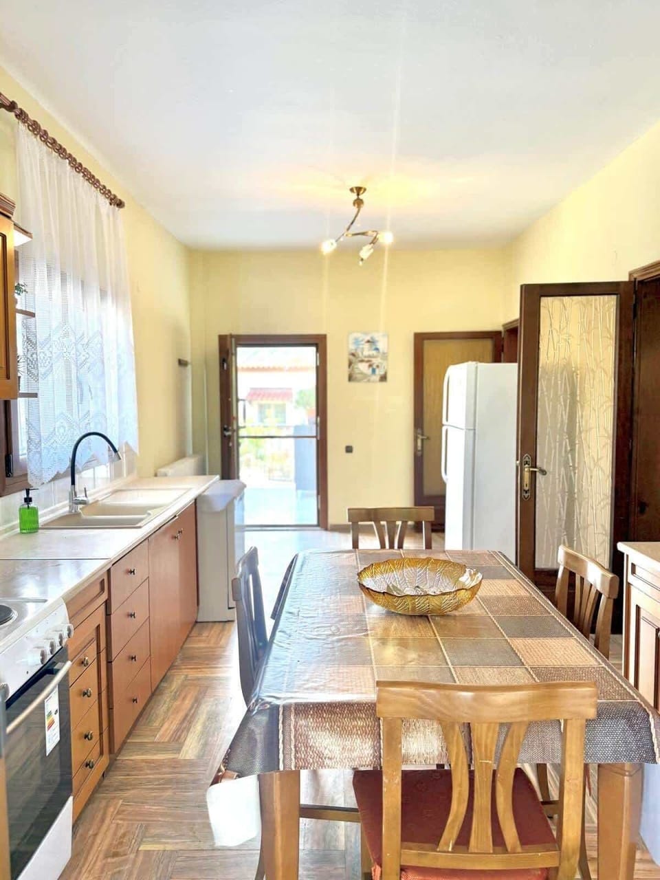 Large kitchen and dining space with natural light and a comfortable table for shared meals with family or friends.
