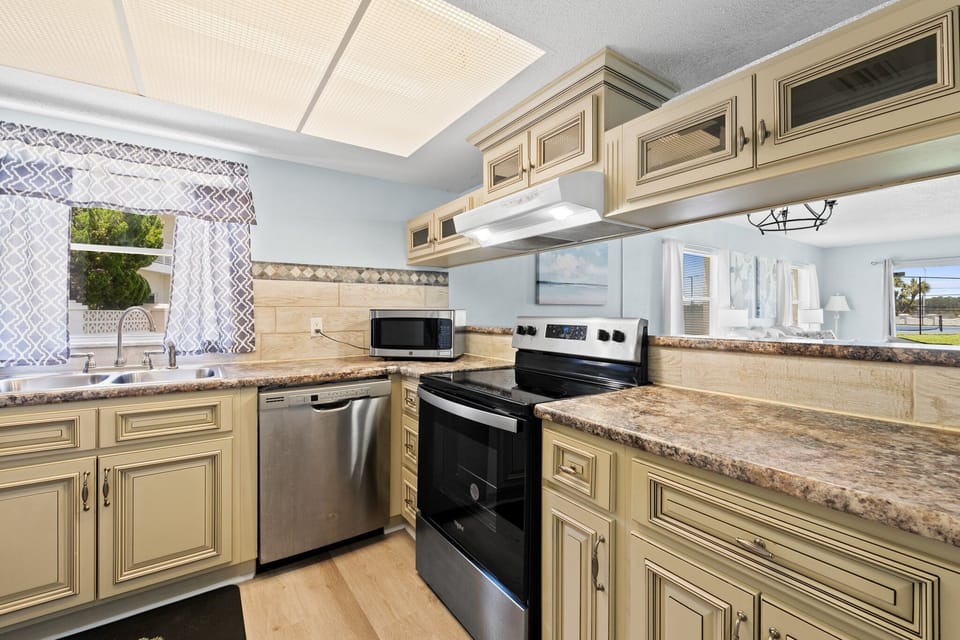 Convenient kitchen area with all the appliances you need for a home-cooked meal