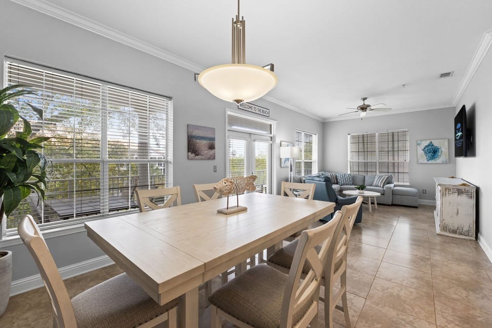 Enjoy meals with a view—sunlight pours in through wide windows in this cozy dining space.
