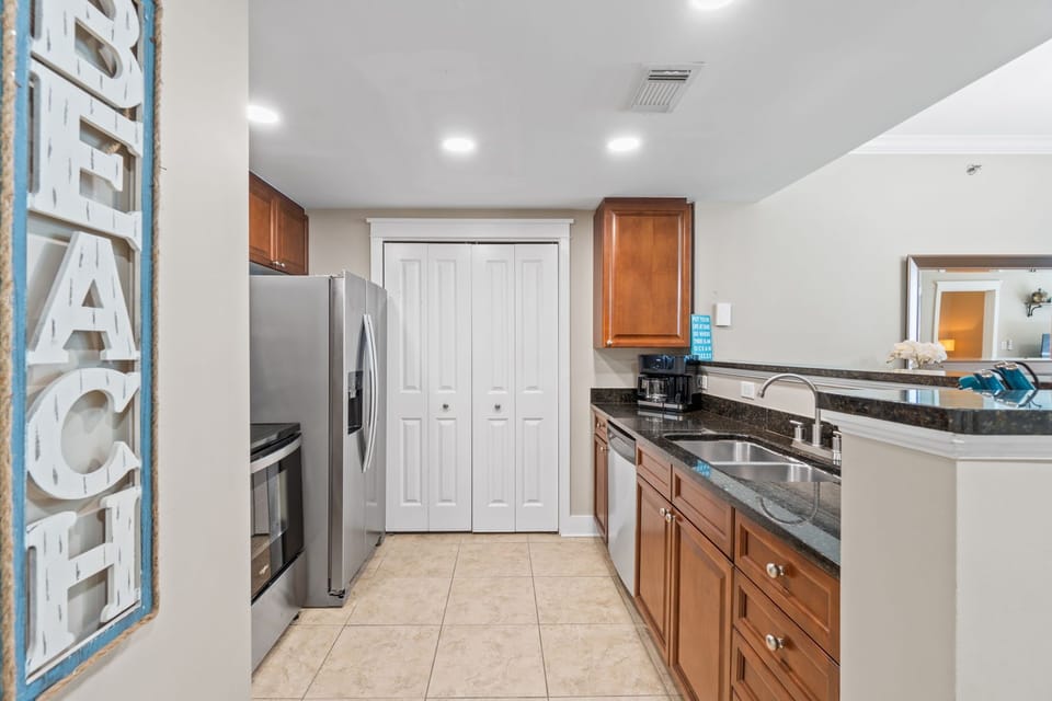 Coastal-style kitchen with all the essentials, open to the dining area and boasting beautiful views toward the balcony.