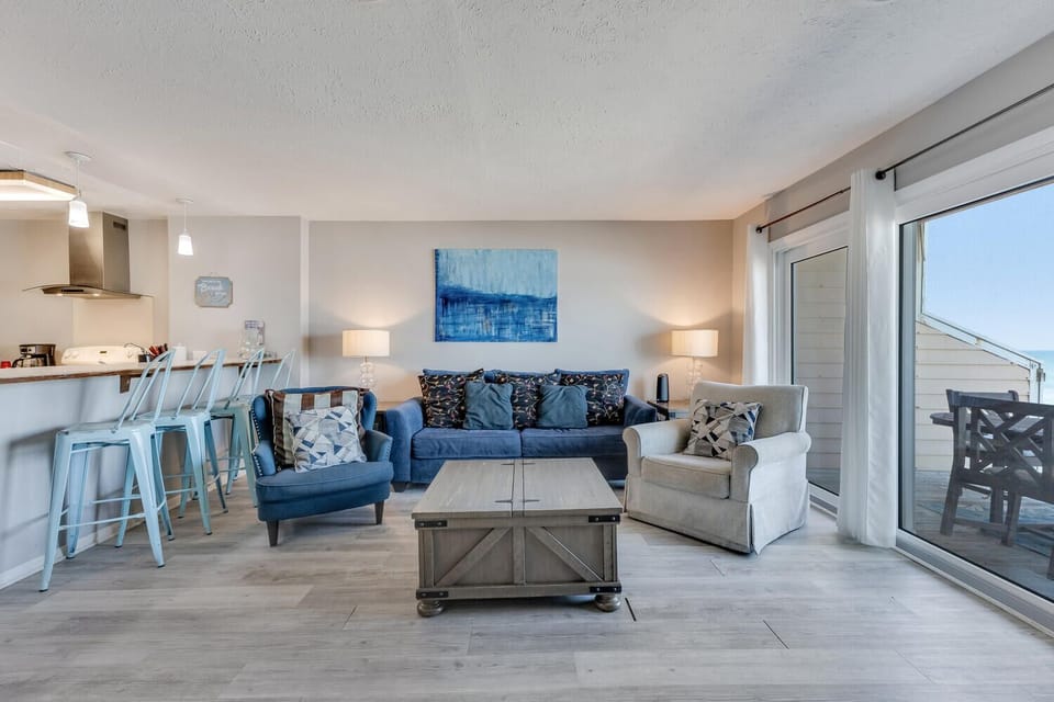 Unwind in your bright, open living space where coastal blues meet modern comfort, perfect for gathering with loved ones.