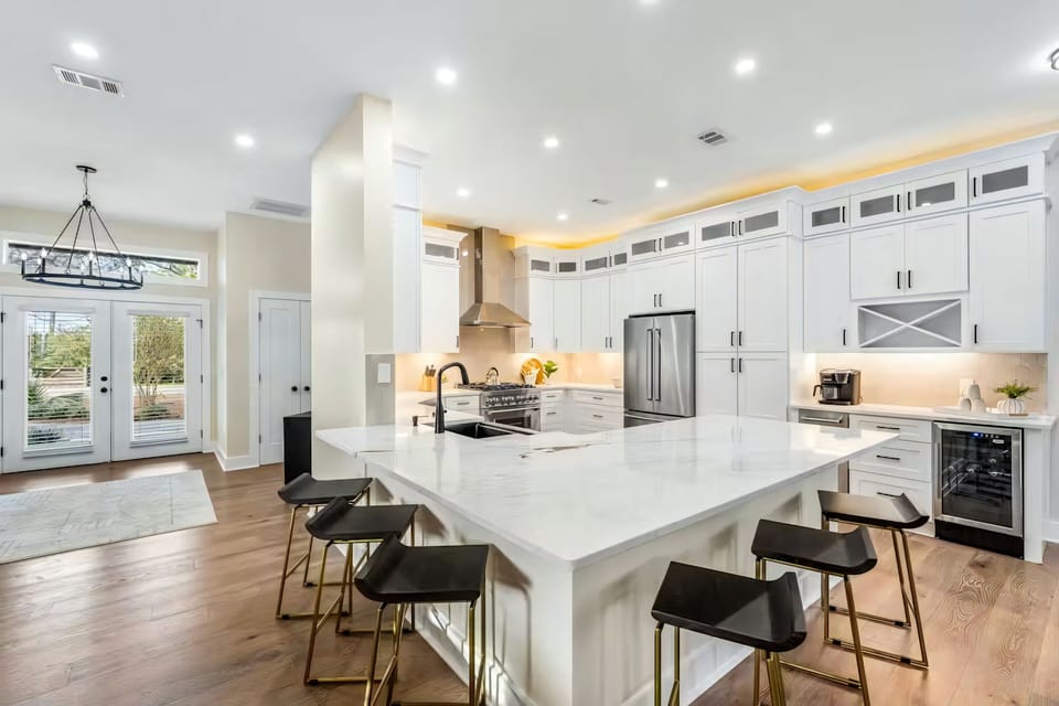 Designed for both cooking and connection, this open kitchen offers a generous island and modern finishes throughout.