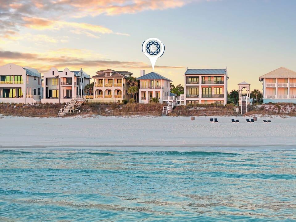 Stunning beachfront vacation rentals line the pristine white sand with crystal-clear turquoise waters just steps away.