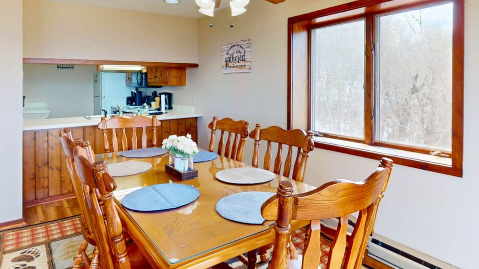 Gather around your spacious dining table for memorable meals while natural light streams through the large windows, creating a warm atmosphere.