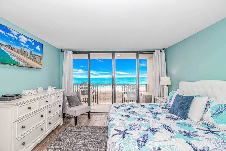 Master bedroom with King bed and Private balcony with sweeping ocean views.