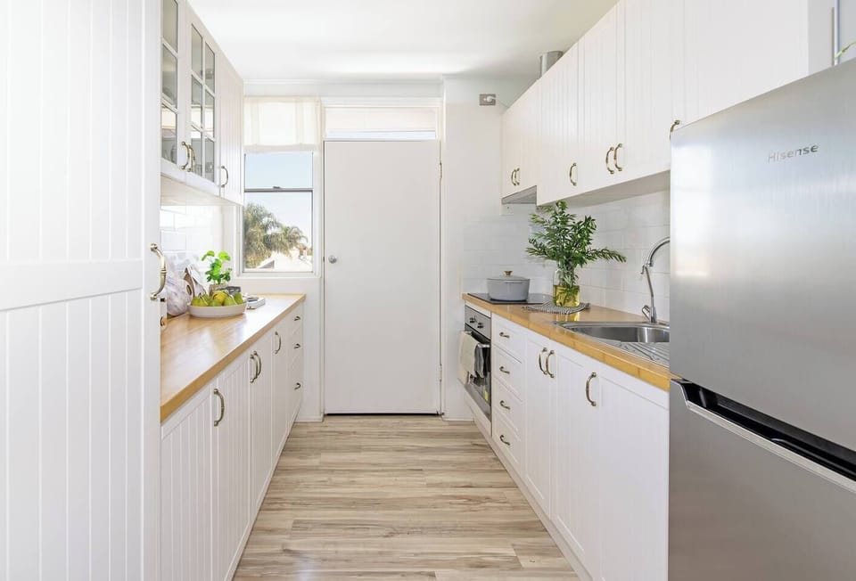 The bright and spacious kitchen leads to the balcony and is equipped with plenty of appliances and utensils for your stay
