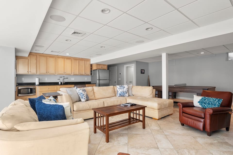 Game room with lounge, TV, ping pong/pool table & sauna.