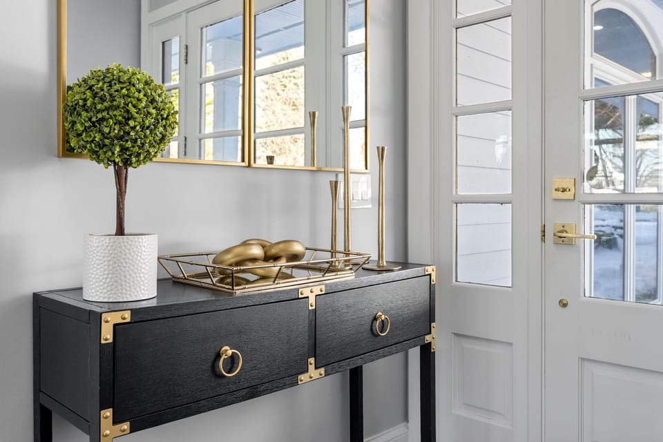 Comfy living room, deck access, fireplace & bay views.