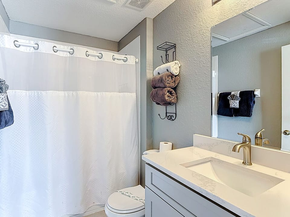 Full bathroom with shower/tub combo and vanity