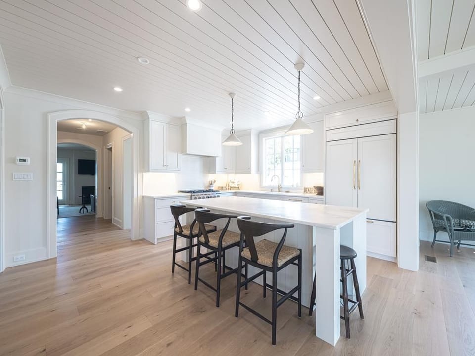 The modern kitchen combines style and functionality with sleek cabinetry, a spacious island, and plenty of natural light.