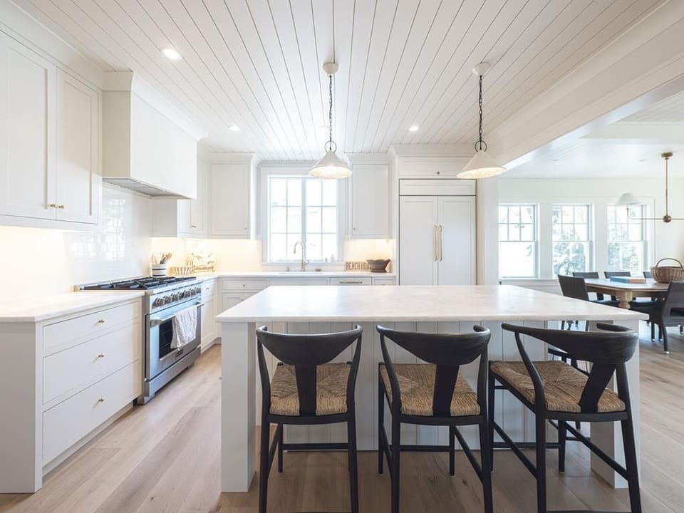 This bright and airy kitchen features elegant finishes and an open layout, making it the heart of family meals and gatherings.