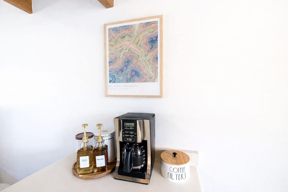 Bright coffee bar with drip brewer, gourmet syrups, coffee, and filters ready