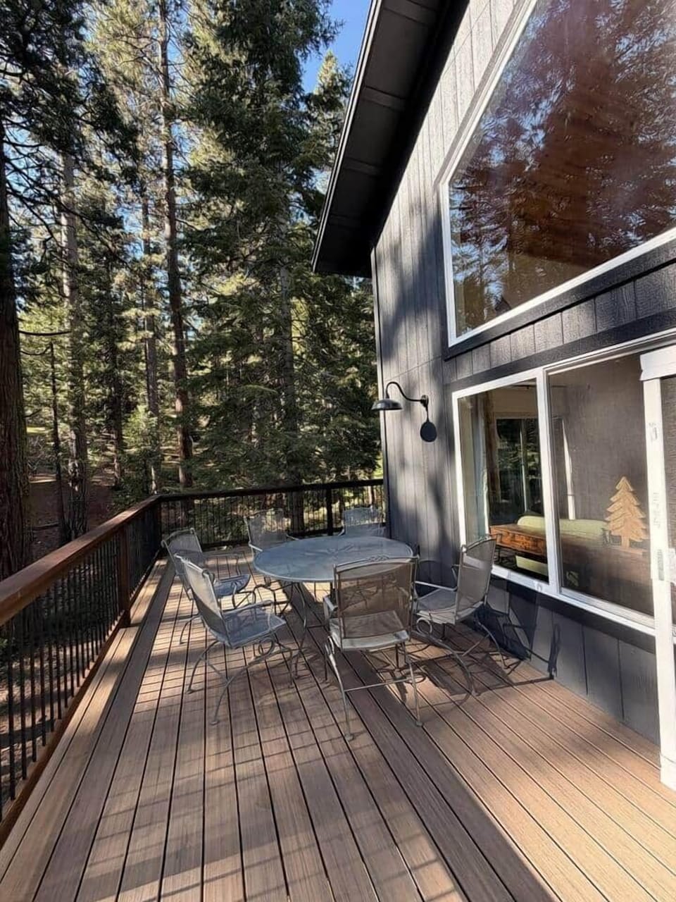 Brand-new wraparound deck with BBQ, dining table and chairs, lounge chair. Perfect for morning coffee, al fresco meals, or relaxing in comfort while enjoying forest views and fresh mountain air.