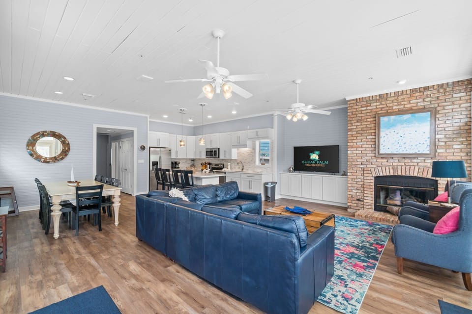 Living area with lots of windows and light and plantation shutters abound,